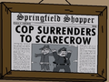 Springfield Shopper Cop Surrenders to Scarecrow.png