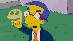 Milhouse holding Muppet-shaped cheese.png